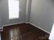 Simple bedroom with dark hardwood floors and window at 141 Rock Ridge Ln, Mount Holly, NC 28120