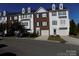 Three-story townhome with a two-car garage and well-maintained landscaping at 141 Rock Ridge Ln, Mount Holly, NC 28120