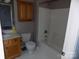 Bathroom with tub, toilet and wood vanity at 141 Rock Ridge Ln, Mount Holly, NC 28120