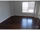 Simple bedroom with dark hardwood floors and window at 141 Rock Ridge Ln, Mount Holly, NC 28120
