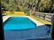 Relaxing kidney-shaped pool surrounded by a wooden fence at 810 N Woodland Dr, Lancaster, SC 29720