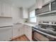 Modern kitchen with white cabinets and stainless steel appliances at 4605 Coronado Dr # M, Charlotte, NC 28212