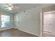 Bedroom with large window, ceiling fan, and wood-look flooring at 4605 Coronado Dr # M, Charlotte, NC 28212