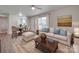 Bright living room with comfy seating and hardwood floors at 4605 Coronado Dr # M, Charlotte, NC 28212