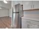 Modern kitchen with stainless steel refrigerator and white cabinets at 4605 Coronado Dr # M, Charlotte, NC 28212