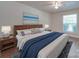 King-size bed, wood nightstands, and blue accents at 4605 Coronado Dr # M, Charlotte, NC 28212