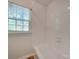 Clean bathroom with a shower/tub combo and white tile at 4605 Coronado Dr # M, Charlotte, NC 28212