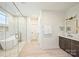 Spa-like bathroom with soaking tub, walk-in shower, and marble tile at 567 Lyttleton Dr, Charlotte, NC 28211