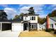 Two-story craftsman style home with gray siding, a white garage door, and landscaping at 1022 W C St, Kannapolis, NC 28081