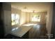 Bright living room with hardwood floors, large windows, and an open floor plan at 1022 W C St, Kannapolis, NC 28081