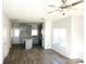 Open concept living room and kitchen with gray cabinets, hardwood floors, and ceiling fans at 1022 W C St, Kannapolis, NC 28081