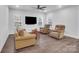 Inviting living room featuring plush seating, a ceiling fan, and natural light from large windows at 1717 Slippery Rock Ln, Monroe, NC 28112