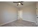 Simple bedroom with ceiling fan and door to bathroom at 204 Wetmore Rd, Woodleaf, NC 27054