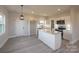 Modern kitchen with white cabinets, granite island, and stainless steel appliances at 204 Wetmore Rd, Woodleaf, NC 27054