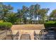 Stone patio with metal chairs and lake view at 178 Stonebridge Dr, New London, NC 28127