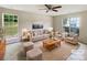 Virtually staged living room with comfy seating and large windows at 3219 Irwin Valley Ct, Charlotte, NC 28269