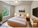 Virtually staged main bedroom with a king bed and large windows at 3219 Irwin Valley Ct, Charlotte, NC 28269