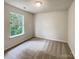 Simple bedroom with carpeted floor and a large window at 3219 Irwin Valley Ct, Charlotte, NC 28269