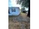 Side yard with patio and mature tree at 560 2Nd St, Chester, SC 29706