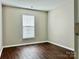 Bright bedroom with window blinds and dark wood floors at 1021 Meadowbrook Sw Ln, Concord, NC 28027