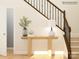 Elegant staircase with dark wood railing and a light-colored console table at 1587 Croyden St, Indian Land, SC 29707