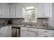 Kitchen with white cabinets, granite countertops, and a double sink at 3979 Stoney Creek Dr, Lincolnton, NC 28092