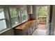 Laundry room with built-in cabinets, wood countertop, and access to a deck at 87 Woodsdale Se Pl, Concord, NC 28025