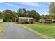 Home with a long paved driveway and a grassy yard at 2117 Charlotte Hwy, Mooresville, NC 28117