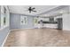 Open living room and kitchen with tile floors and ceiling fan at 2117 Charlotte Hwy, Mooresville, NC 28117