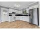 White kitchen cabinets, stainless steel appliances, and tile floors at 2117 Charlotte Hwy, Mooresville, NC 28117