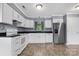 Kitchen with white cabinets, granite countertops, and stainless steel appliances at 2117 Charlotte Hwy, Mooresville, NC 28117