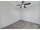 Simple bedroom with ceiling fan and grey vinyl flooring at 2030 Vinton St, Charlotte, NC 28216