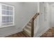 Staircase with wood railing and neutral carpeting at 4004 Crooked Spruce Ct, Matthews, NC 28105