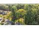 Aerial view showing a house nestled in a wooded neighborhood at 201 Smithfield Dr, Charlotte, NC 28270