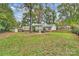 Backyard view of house and surrounding trees at 3920 Pemberton Dr, Charlotte, NC 28210