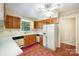 Kitchen features wood cabinets, tile floor, and a dishwasher at 2643 Rolling Hills Dr, Monroe, NC 28110