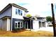 Modern duplex with gray and beige siding, white garage doors and black accents at 1024 W C St, Kannapolis, NC 28081