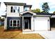 Two-story home with gray and beige siding, black door, and attached garage at 1024 W C St, Kannapolis, NC 28081