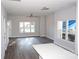 Bright living room with hardwood floors, large windows, and ceiling fan at 1024 W C St, Kannapolis, NC 28081