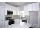 Modern kitchen with white cabinets, stainless steel appliances and quartz countertops at 1024 W C St, Kannapolis, NC 28081