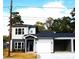 Two-story home with gray and beige siding, black door, and attached garage at 1024 W C St, Kannapolis, NC 28081