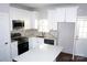 Modern kitchen with white cabinets, stainless steel appliances and quartz countertops at 1024 W C St, Kannapolis, NC 28081