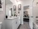 Double vanity bathroom with a view into a bedroom at 6213 Barcelona Way, Charlotte, NC 28214