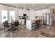 Modern kitchen with white cabinets, island, stainless steel appliances, and hardwood floors at 6224 Barcelona Way, Charlotte, NC 28214