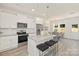 Modern kitchen with white cabinets and granite island at 2612 Senior Dr, Charlotte, NC 28216