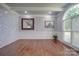 Living room with hardwood floors, white wainscoting, and marble tile accent wall at 211 Bullfinch Rd, Mooresville, NC 28117