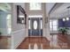 Bright entryway with hardwood floors, a large mirror, and a decorative door at 211 Bullfinch Rd, Mooresville, NC 28117