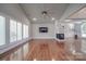 Open living room with hardwood floors, high ceilings, and plantation shutters at 211 Bullfinch Rd, Mooresville, NC 28117