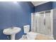 Bathroom with shower, toilet, and pedestal sink at 18210 Pompano Pl, Cornelius, NC 28031