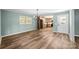 Dining room with hardwood floors, chandelier, and access to kitchen at 1251 Magnolia St, Albemarle, NC 28001